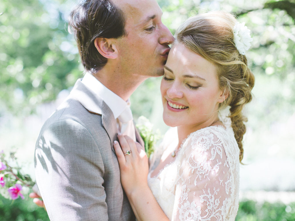 Bride and groom kissing for their wedding photo